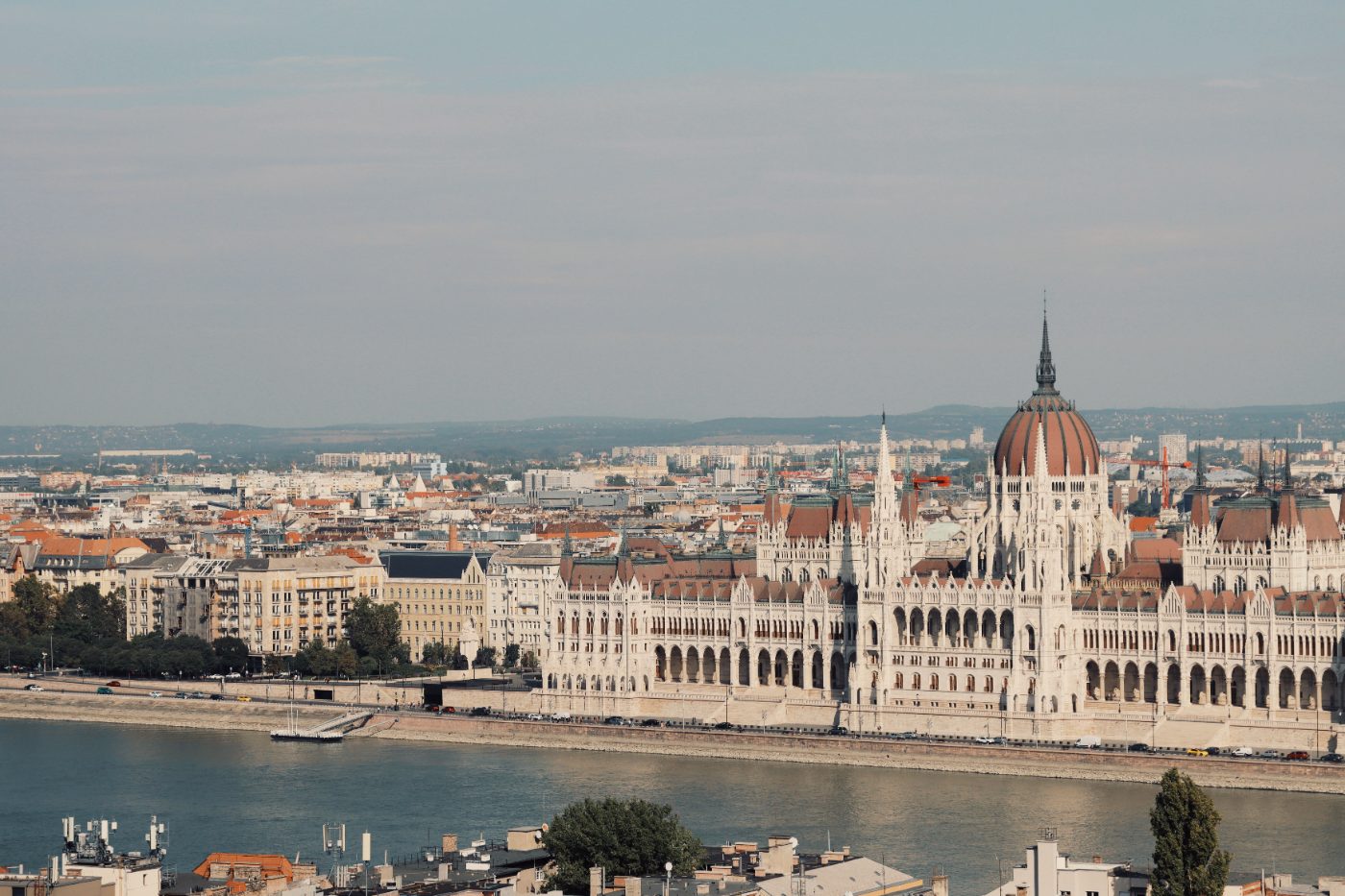Scenic view of the iconic Hungarian Parliament Building along the Danube River in Budapest.