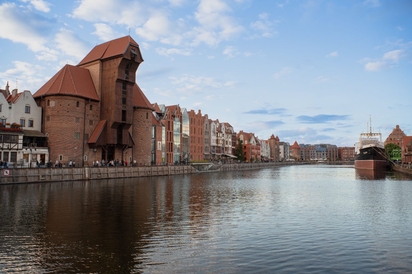 Beautiful view of Gdańsk's iconic waterfront featuring historic architecture and a moored ship.