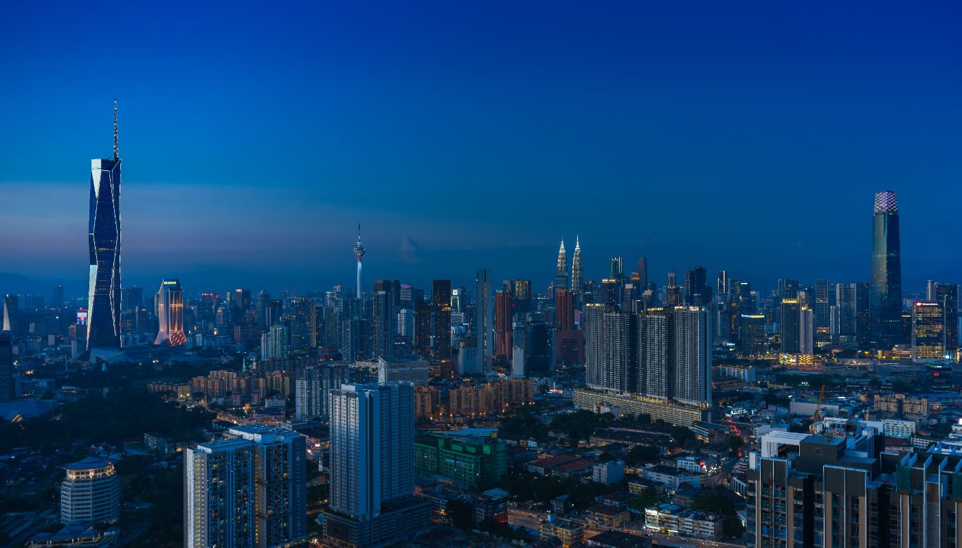 Discover the vibrant Kuala Lumpur skyline featuring iconic landmarks in the evening glow.