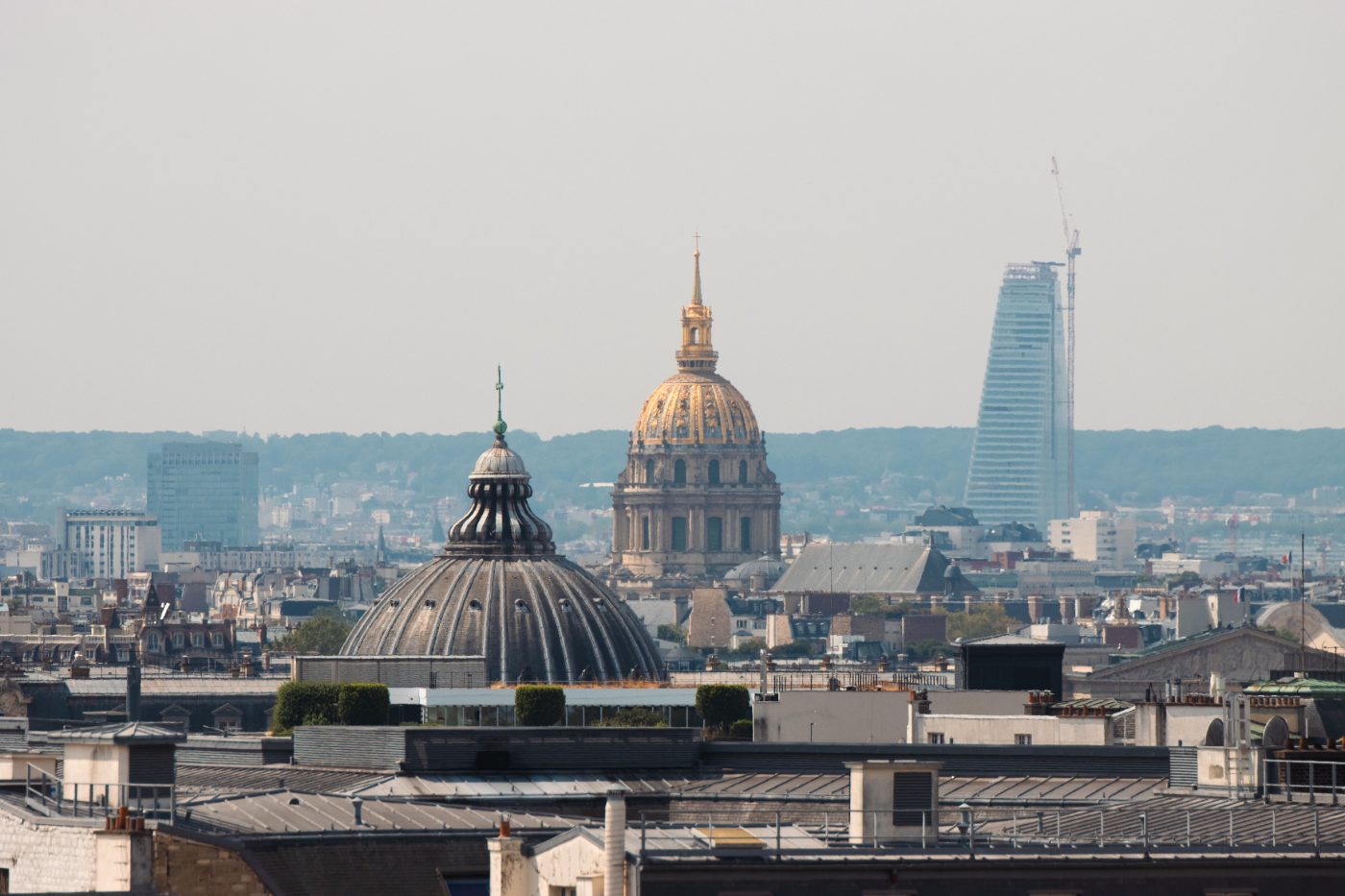A captivating aerial view of the Paris skyline featuring historic domes and modern buildings.
