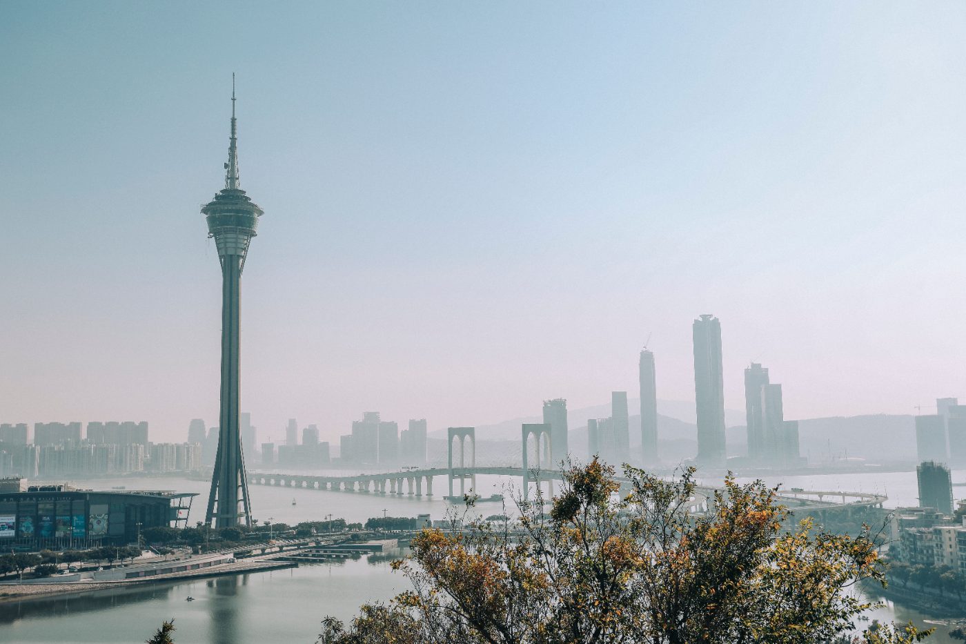 A beautiful urban skyline with a prominent tower and bridge under a clear sky, creating a serene cityscape.