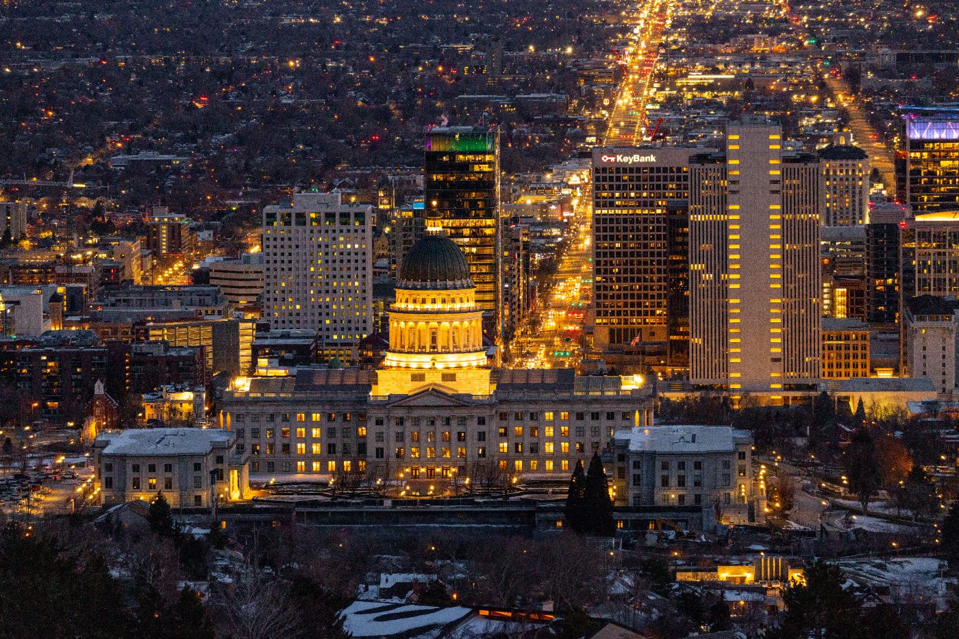 Stunning aerial view of Salt Lake City skyline featuring the Utah State Capitol illuminated at night.